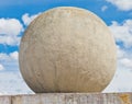 Concrete sphere against a sky background