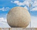 Concrete sphere against a sky background