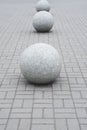 Concrete sphere on a parapet in park. Architecture of the park. A large stone balls lies on a stone pavement