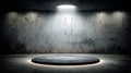 A concrete stage of considerable size is illuminated by a single spotlight Royalty Free Stock Photo