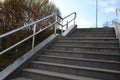 concrete staircase with stainless steel polished tubular railing. Royalty Free Stock Photo