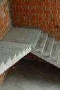 Concrete stairs in a new building near a brick wall. Start of construction Royalty Free Stock Photo