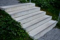 Concrete stairs to the park serving at the same time as a sitting bench. gray cement clean smooth bright cement surface. granite c Royalty Free Stock Photo