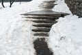 Concrete stone staircase covered with dirty deep slippery snow after blizzard snowstorm snowfall at city pedestrian