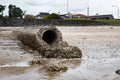 Concrete stormwater pipe draining rain water into sea Royalty Free Stock Photo