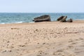 Concrete structures on the beach, construction debris on the shore Royalty Free Stock Photo