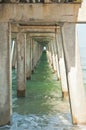 Concrete supports for a wood pier, jutting into tropical waters of the gulf of Mexico