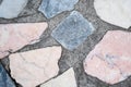 Concrete surface with multiple patches of colored stones. Closeup Royalty Free Stock Photo