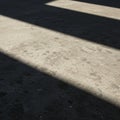 Concrete surface with rectangular shadows creates a pattern of light and dark areas. Royalty Free Stock Photo
