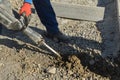 The concrete surface of the road was dug and drilled by construction road workers using a jackhammer Royalty Free Stock Photo
