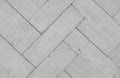 Concrete tiles arranged in a herringbone pattern. The grey surface shows subtle texture variations and fine-grained aggregate. Royalty Free Stock Photo