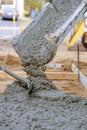 Concrete truck with pouring cement during to residential street sidewalk Royalty Free Stock Photo