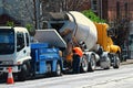 Concrete truck unloading its liquid concrete into a concrete pumper
