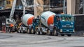 Concrete trucks in a construction site with workers Royalty Free Stock Photo