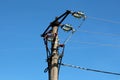 Concrete utility pole with multiple electrical wires connected with ceramic and glass insulators