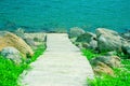 Concrete walkway in the island go down to lake background