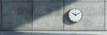 Concrete wall featuring a minimalist white clock Royalty Free Stock Photo