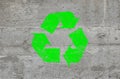 Concrete wall with green recycling logo sign Royalty Free Stock Photo