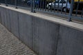 concrete wall with low galvanized metal railing by the road. protective barrier of Royalty Free Stock Photo