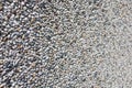 Concrete wall with pebbles in close-up. Royalty Free Stock Photo