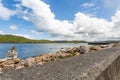 Concrete wall with rocks serving as breakwater on the Inishbofin Island