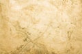 A concrete wall with scuffs and cracks of yellowed color. Yellow background with cement texture Royalty Free Stock Photo