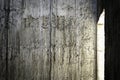 A concrete wall that shines through with light through the window in an abandoned building, Concrete surface caused by the flow of