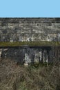 Concrete wall with stones and jutty in front of blue sky Royalty Free Stock Photo