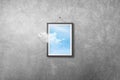 White cloud flying out from picture or photo frame that hanging on concrete wall grunge texture background.