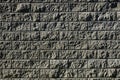 Concrete wall from texture blocks. high dividing noise wall of the yard. The wall is equipped with a sheet metal roof, which preve
