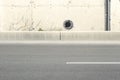 Concrete wall texture with a round ventilation hole. Royalty Free Stock Photo