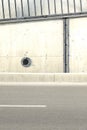 Concrete wall texture with a round ventilation hole. Royalty Free Stock Photo