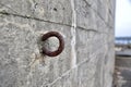 Rusty Iron Ring   Concrete Wall, textured with shuttering marks. WW2 German Gun emplacement, Kristainsand, Norway. Royalty Free Stock Photo