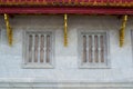 Concrete wall and wooden windows of Buddha image hall of Wat Phra Sing Wora Maha Wihan. Wat Phra Sing is a Buddhist temple