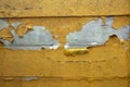 Concrete wall with yellow, orange peeling paint old cracked damaged rough bright background texture Royalty Free Stock Photo