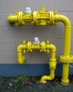 Concrete wall , yellow pipes, plumbing industry.