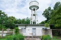 Concrete water tank tower factory in the garden Royalty Free Stock Photo