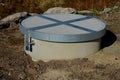 Concrete well well covered with a round concrete lid. a fall into a well often ends tragically with drowning, suffocation or fract Royalty Free Stock Photo