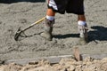 Concrete worker leveling the wet mud on a newly poured driveway. Royalty Free Stock Photo