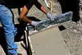 Concrete worker levels the mud on a foundation project Royalty Free Stock Photo