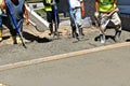 A team of concrete laborers work on the pouring of a new patio, Royalty Free Stock Photo