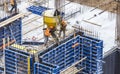 Concreting work at the construction site. ÃÂ¡onstruction workers pour liquid concrete from cement concrete hopper to fromwork Royalty Free Stock Photo