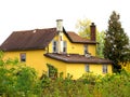 Condemned and abandoned yellow city house.