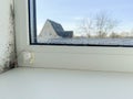 Condensation Droplets on Window Sill with Blurry View of House and Tree on Sunny Day Royalty Free Stock Photo