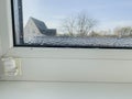 Condensation Droplets on Window Sill with Blurry View of House and Tree on Sunny Day Royalty Free Stock Photo