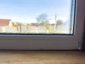 Condensation Droplets on Window Sill with Blurry View of House and Tree on Sunny Day Royalty Free Stock Photo
