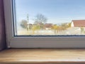 Condensation Droplets on Window Sill with Blurry View of House and Tree on Sunny Day Royalty Free Stock Photo