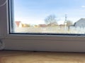Condensation Droplets on Window Sill with Blurry View of House and Tree on Sunny Day Royalty Free Stock Photo