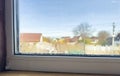 Condensation Droplets on Window Sill with Blurry View of House and Tree on Sunny Day Royalty Free Stock Photo