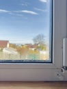 Condensation Droplets on Window Sill with Blurry View of House and Tree on Sunny Day Royalty Free Stock Photo
